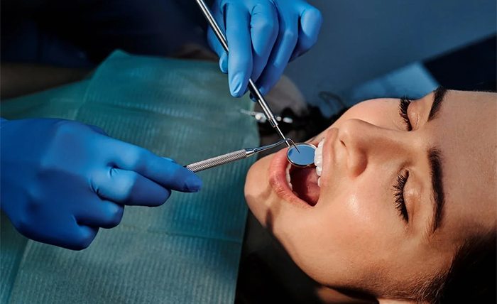 How do dentists perform dental implant surgery?