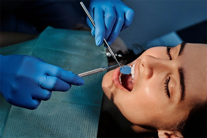 How do dentists perform dental implant surgery?